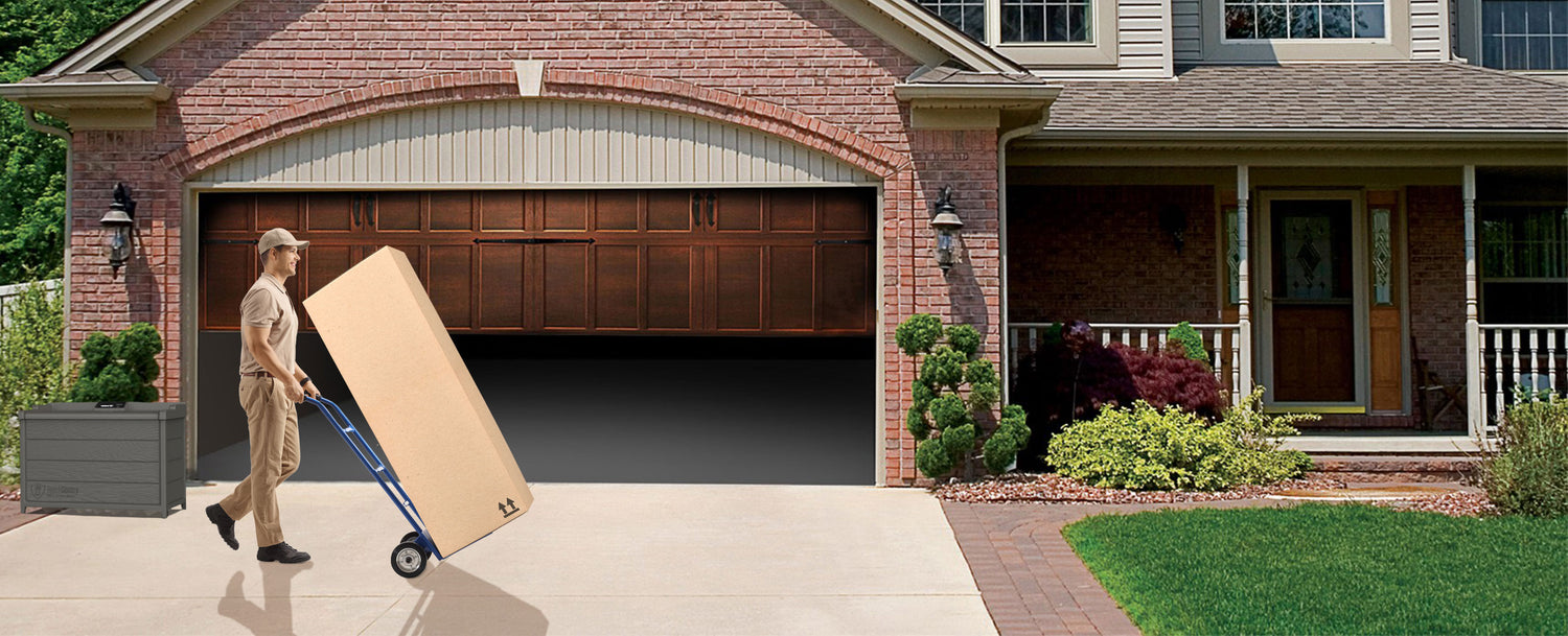 Delivery person entering the garage with a large package on a dolly