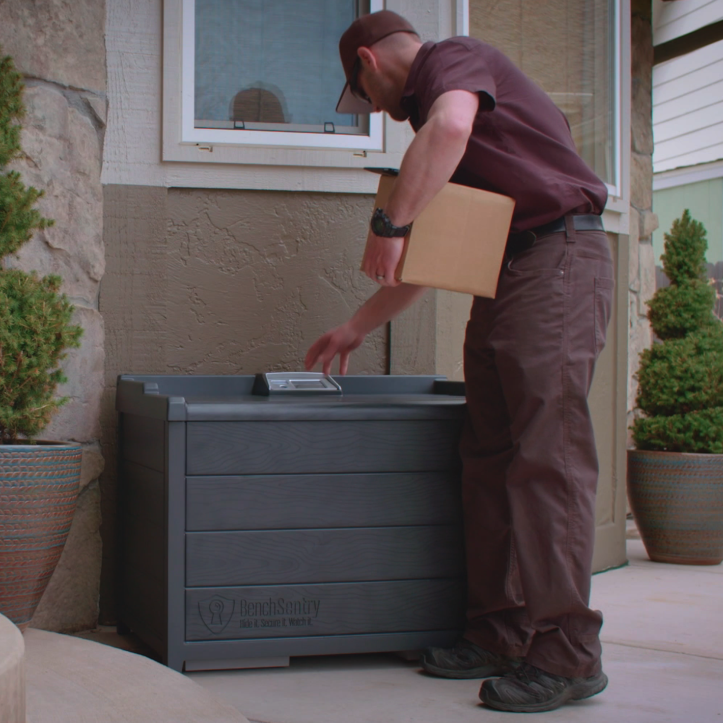 Delivery driver placing a package into a BenchSentry Connect Package Delivery Box
